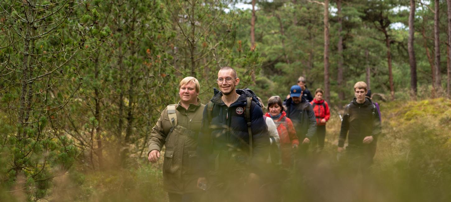  A group on a hike in green surroundings